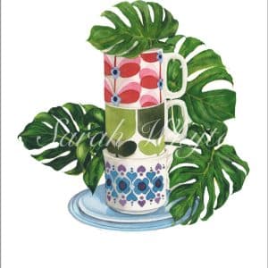 A stack of three colorful floral vintage mugs on a turquoise saucer, set against several green leaves of Monstera Deliciosa, against a white background